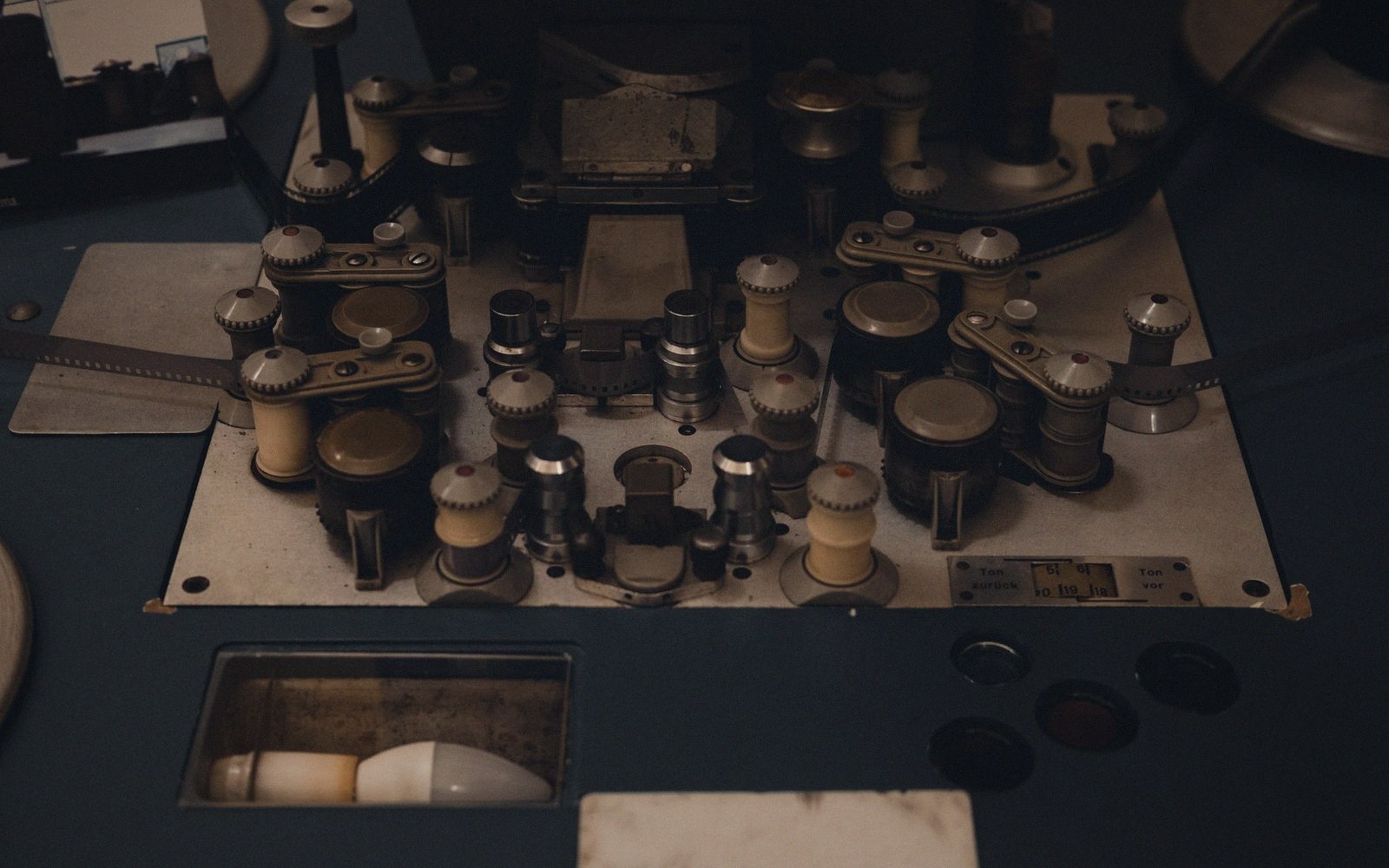 Close-up of gears, knobs and reels on a vintage film editing machine