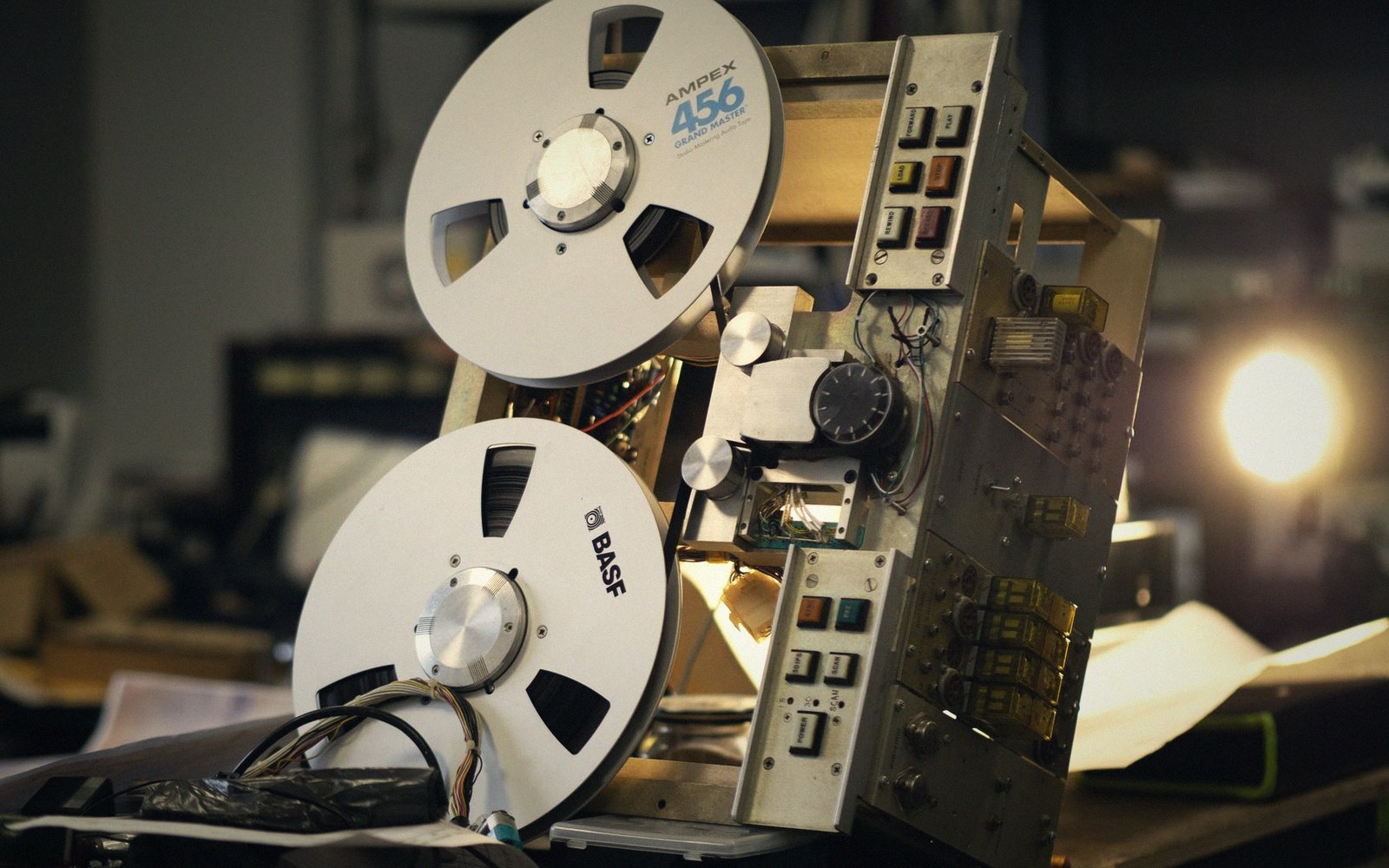 A reel-to-reel machine with tape looped over a pencil